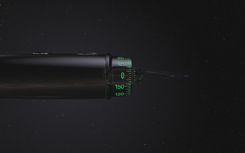 Rotating black corneal eye marker suspended in space. Green arrows point down to note the finger brake button.